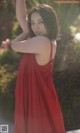 A woman in a red dress posing for a picture.