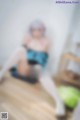 A blurry image of a woman sitting on a chair.